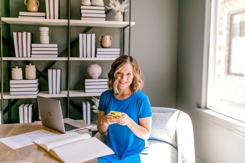 A coordinator smiling on a call at her desk, ready to help