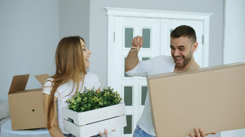 Happy couple celebrating as they receive the keys to their new home