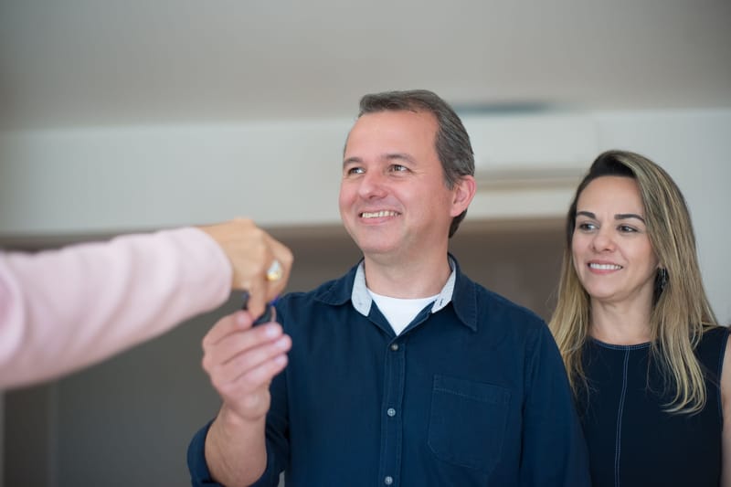 A couple receiving the keys to their new home at closing