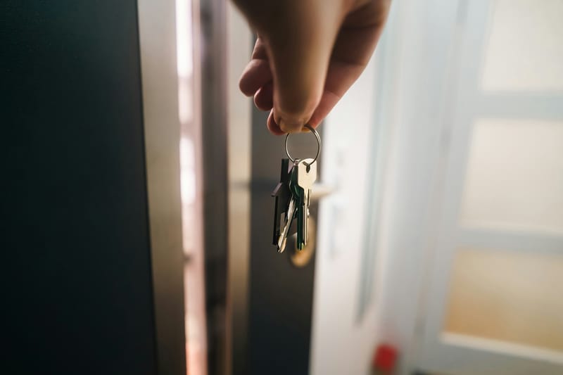 House keys in hand at the open front door
