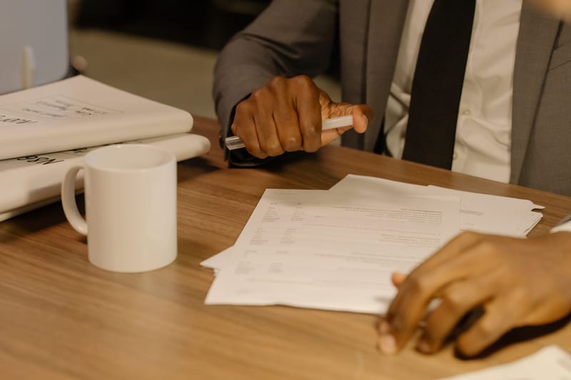 Reviewing contract paperwork line by line at the desk